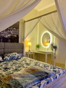 a bedroom with a bed and a table and a mirror at Studio Appartment in Building in Ras al Khaimah