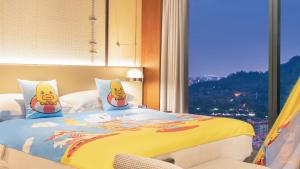 a bed with two simpsons pillows in a room with a window at InterContinental Dongguan, an IHG Hotel in Dongguan