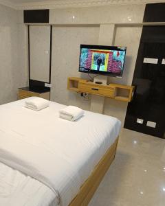 Letto o letti in una camera di Arasan Residency