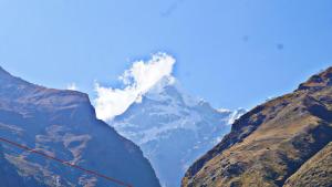 a view of a snow covered mountain in the distance at Hotel Inn Badrinath Stay in Badrīnāth