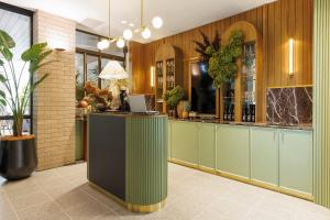 a restaurant with a bar with a laptop on a counter at 202 Elizabeth Hotel - The Surry - Australia in Sydney