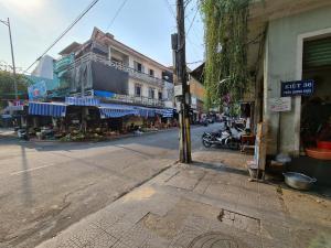 an empty street in an asian city with buildings at Banana homestay( Chuối Homestay) in Hue