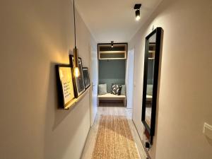 a hallway with a mirror and a couch in a room at Appartement No 1 - Usedom in Zirchow +6 photos