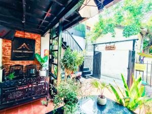 an outdoor patio with a stove and plants at Căn hộ Studio-Banana Homestay in Hue