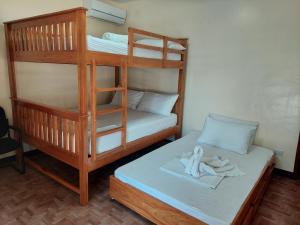 a room with two bunk beds with towels on a bed at MaClare Resort in Imus