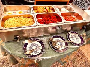a buffet with bowls and plates of food on a table at 34 Silver Rooms in Tbilisi City