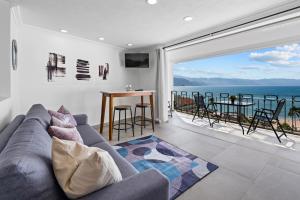 a living room with a couch and a view of the ocean at Luxury Condo just steps away from the Beach! in Puerto Vallarta