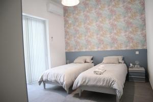 Postel nebo postele na pokoji v ubytování Wardija Maisonette