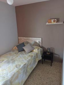 a bedroom with a bed and a table with a lamp at La viña de camarata in Aguilar de la Frontera
