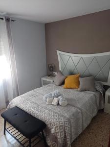 a bedroom with a large bed with a large headboard at La viña de camarata in Aguilar de la Frontera