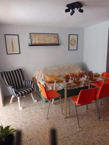 a living room with a table and chairs and a couch at La viña de camarata in Aguilar de la Frontera