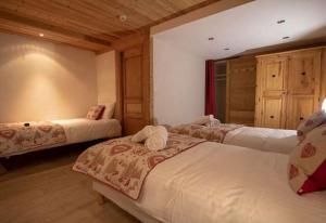a bedroom with three beds with towels on them at Chalet Tavernier in Morzine