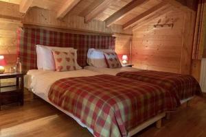 a bedroom with a large bed in a cabin at Chalet Tavernier in Morzine