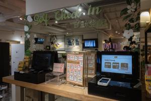 a store with a counter with a cell phone on it at Mini Hotel Causeway Bay in Hong Kong
