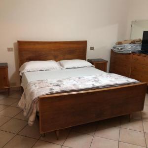 1 cama en un dormitorio con cabecero de madera en Il Castello en CastellʼArquato