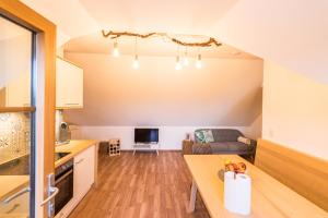 a kitchen and living room with a table and a couch at Weingut Dietl in Riegersburg