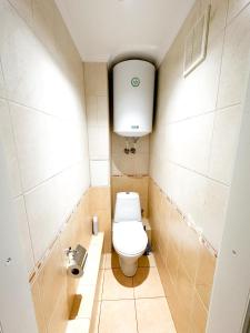 a small bathroom with a toilet and a sink at Central Apartment Pietonala in Chişinău