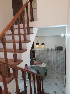 een trap in een huis met twee hanglampen bij Cozy Cove - Newly built 3BHK Duplex with rare valley view in Shimla