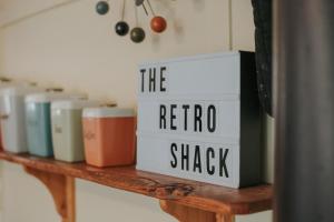 a shelf with a sign that reads the retro shrak at The ReTrO Beach Shack in Aldinga Beach