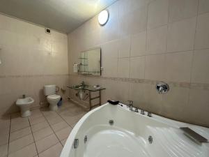 a bathroom with a bath tub and a toilet at ОРДА in Shymkent