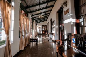 a hallway of a building with wooden floors and windows at Lakefront Home Hotel in Ooty