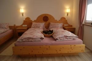 a bedroom with a wooden bed with a bowl on it at Haus Elena in Längenfeld