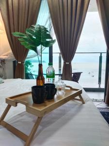 a coffee table with a plant on top of a bed at LurrVe Dê' SĒÀ # Imperium Resident Kuantan in Kuantan