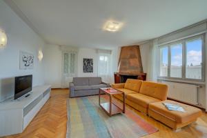 a living room with a couch and a television at Margherita near lake-child friendly - Happy Rentals in Toscolano Maderno