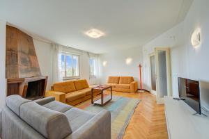 a living room with a couch and a tv at Margherita near lake-child friendly - Happy Rentals in Toscolano Maderno