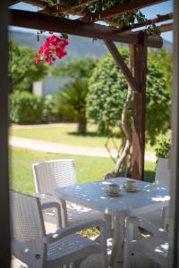 a blue table and chairs on a patio with a table at Citrus Tree Gardens in Kyrenia