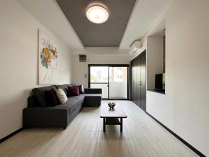 a living room with a couch and a coffee table at Luxes - 2Br Apt for 10ppl Very Good Location in Hijiyamachō