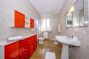 a bathroom with a white sink and a toilet at Margherita near lake - Family Friendly - Happy Rentals in Toscolano Maderno