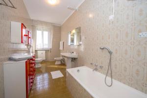 a bathroom with a tub and a toilet and a sink at Margherita near lake - Family Friendly - Happy Rentals in Toscolano Maderno +31 photos
