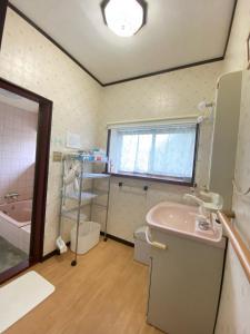 a bathroom with a sink and a toilet and a tub at Guest house Yamabuki - Vacation STAY 13196 in Toyama