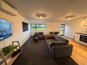 a living room with a couch and a flat screen tv at Countryside peace and comfort , in Cambridge