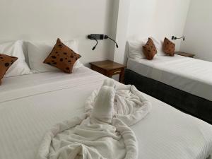 Postel nebo postele na pokoji v ubytování Malindu Yala Gate