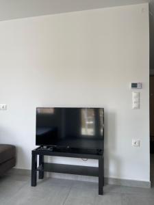 a flat screen tv sitting on a table in a living room at Athenian Modern 2BD Apt next to Metro Panepistimio in Athens