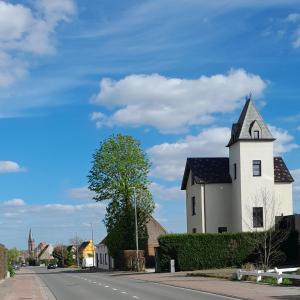 a white church on the side of a street at K's Torentje in Kruishoutem +16 photos