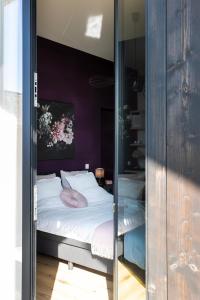a bedroom with a bed in a glass enclosure at K's Torentje in Kruishoutem