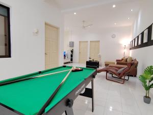 a living room with a pool table at Sunway Tambun Salesman Stay 5 Bedroom 10pax by IWH in Ipoh