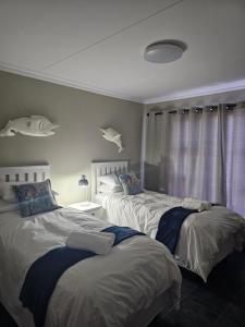 a bedroom with two beds and a window at Amberdale Estate Self Catering in Queenstown