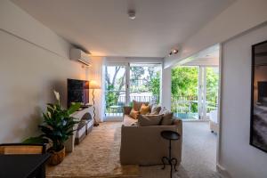 a living room with a couch and a table at Riverside Studio apartment in Brisbane