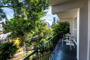 a balcony of a house with a table and chairs at Riverside Studio apartment in Brisbane