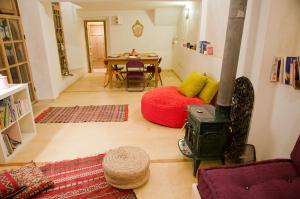 a living room with a wood stove and a table at Riad La Maison D'à Côté in Meknès