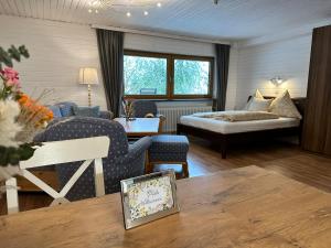 a hotel room with a bed and a living room at Appartement Tegelberg in Steingaden