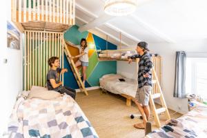 een groep mensen in een slaapkamer met stapelbedden bij SURF HOSTEL BIARRITZ in Biarritz