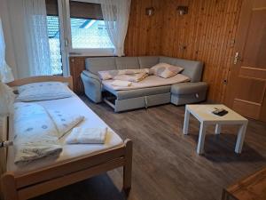 a living room with two beds and a couch at Kiara Apartments & Rooms in Jesenice