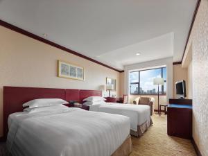 Postel nebo postele na pokoji v ubytování Beijing Poly Plaza Hotel