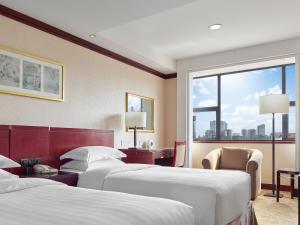 Postel nebo postele na pokoji v ubytování Beijing Poly Plaza Hotel