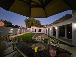 a patio with a table and chairs in a yard at Li-Bru Self Catering Accommodation in Windhoek